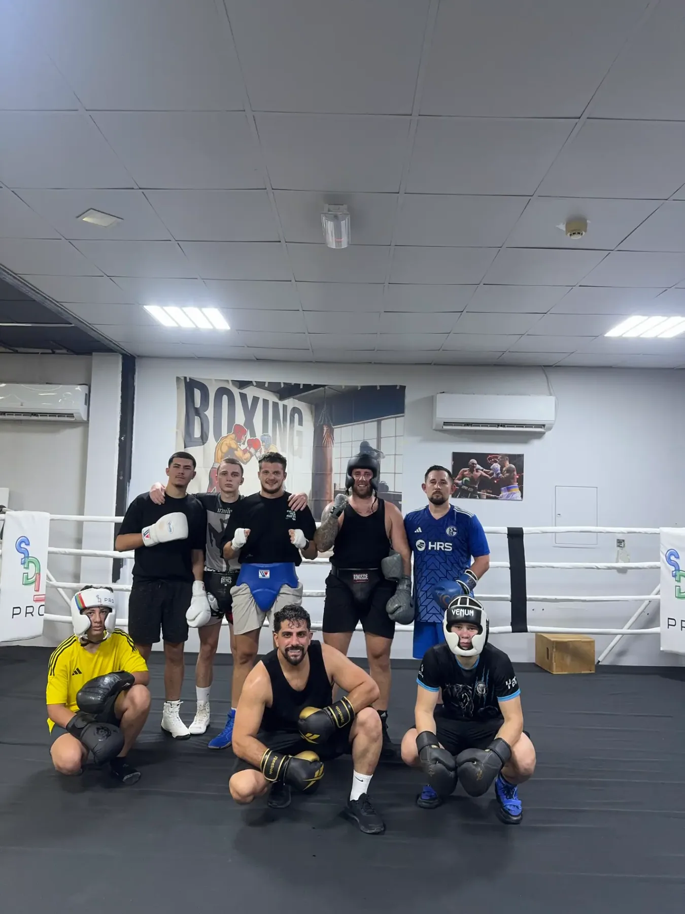 Adult boxers training together inside the SMASH Olympic ring