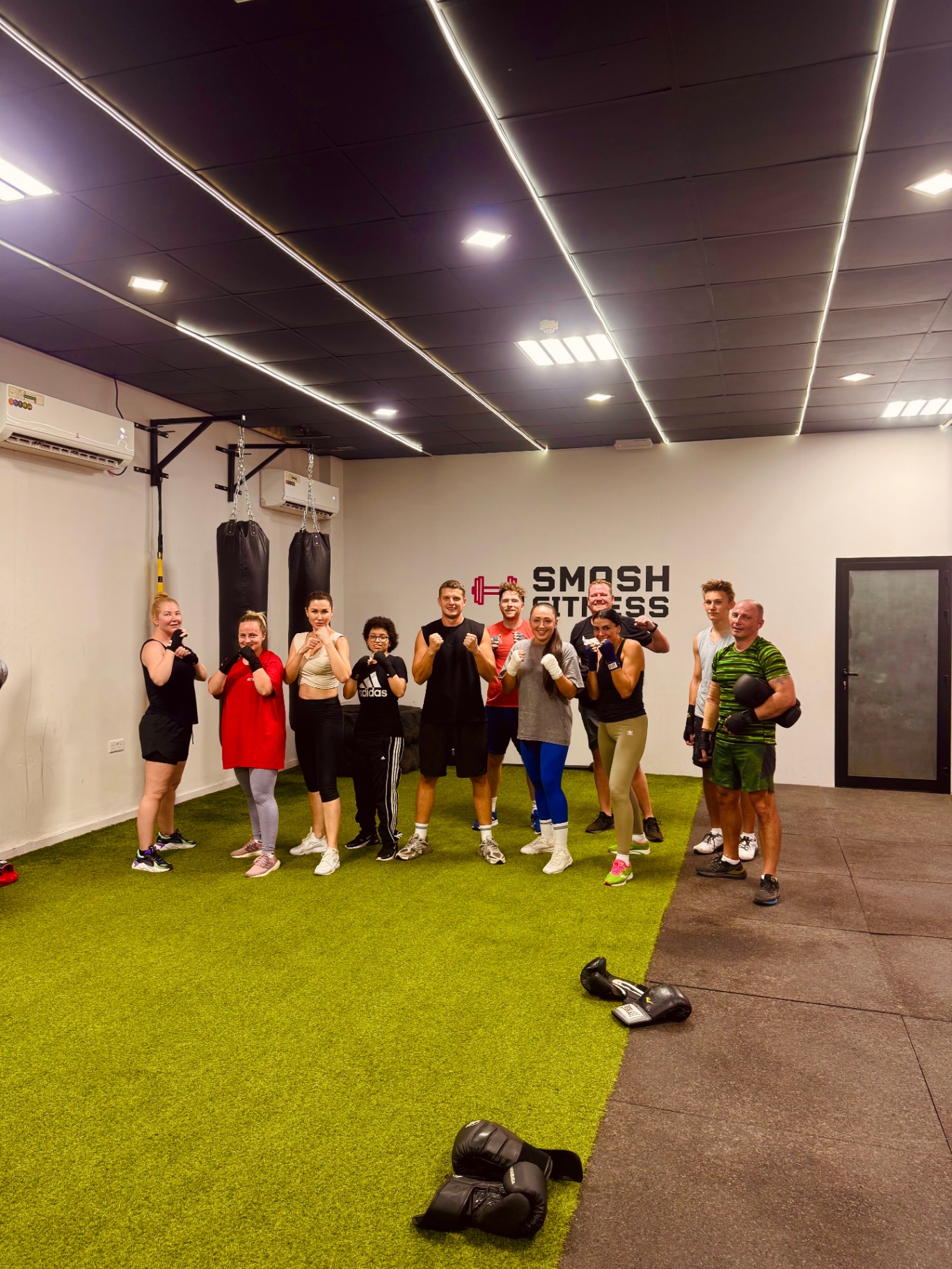 Mixed adult boxing class — men and women training together at SMASH Ras Al Khaimah